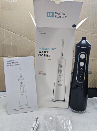 Water flosser shown with product packaging and accessories