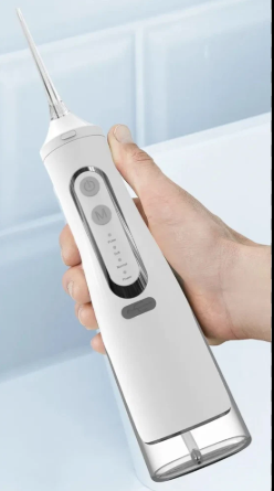 White cordless water flosser in hand